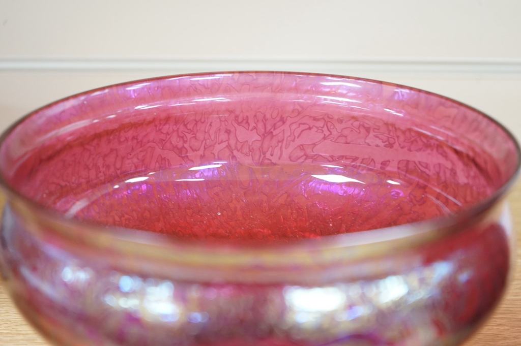 An iridescent art glass pedestal bowl and similar vase, bowl 20cm diameter. Condition - good